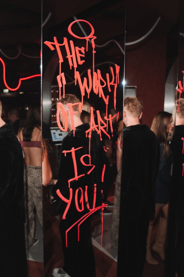 Mirror with red lettering: the work of art is you